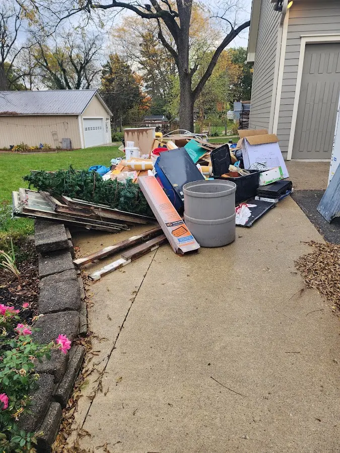 Dumpster being loaded with debris for Residential Dumpster Rental in East Rockingham